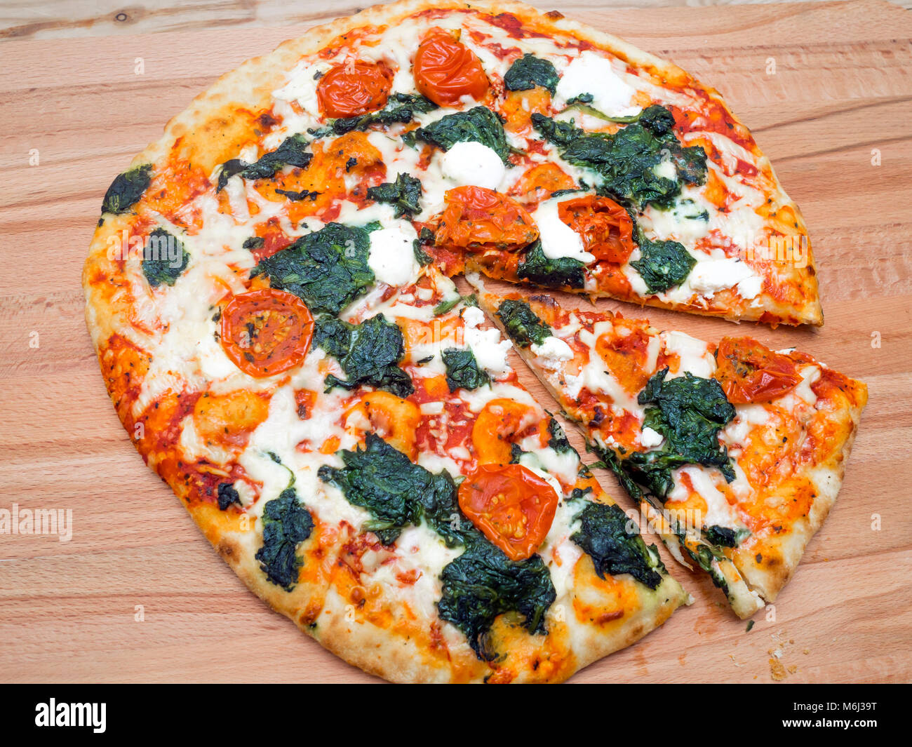 Stonebaked Pizza with Spinach Ricotta mozarella cheese and tomatoes