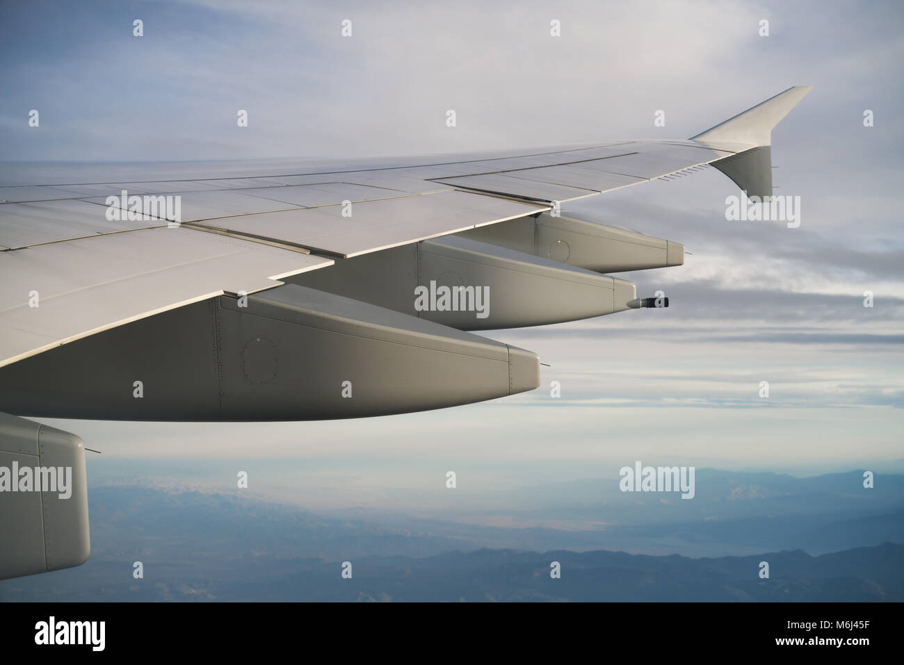 view of airplane wing during flight in midday Stock Photo - Alamy