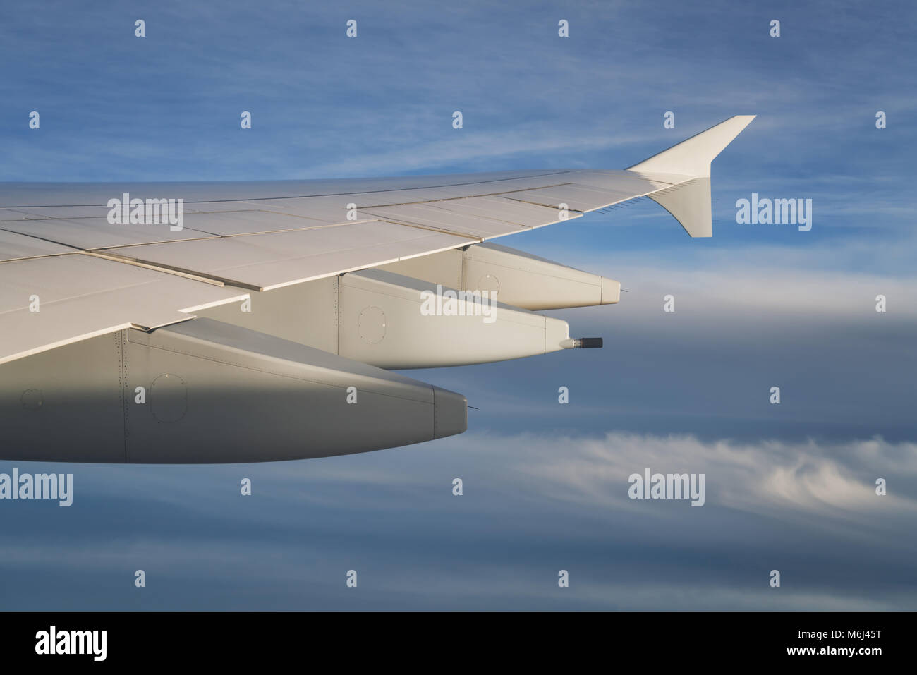 view of airplane wing during flight in midday Stock Photo - Alamy