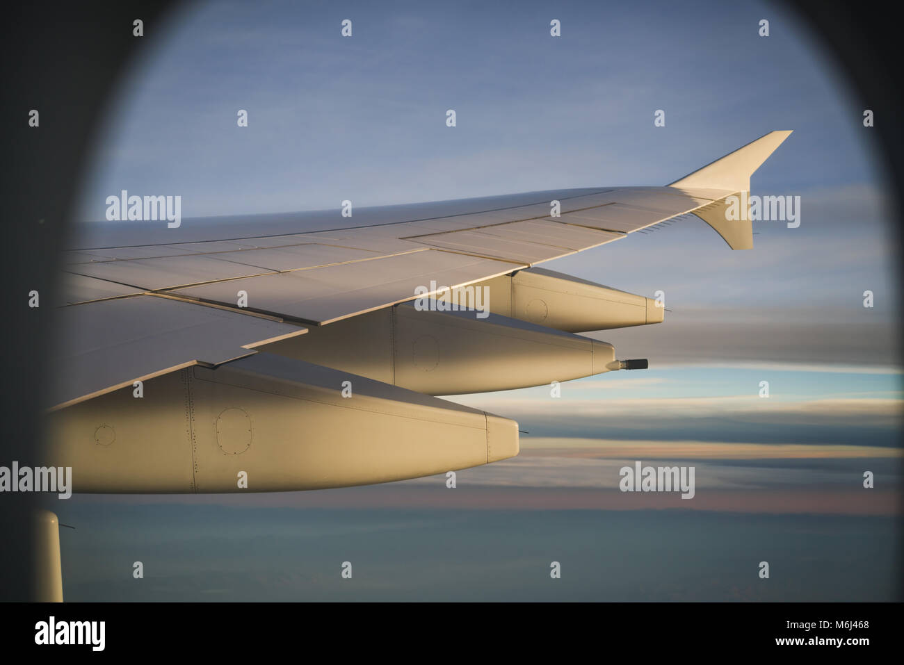 view of airplane wing during flight in sunset Stock Photo - Alamy