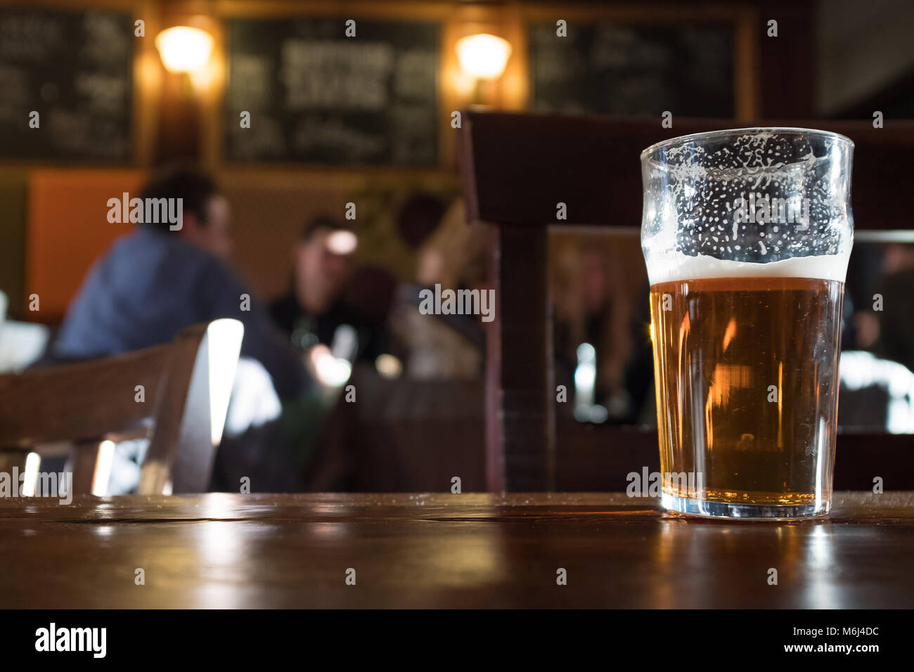 Half drunk pint of beer in pub, Camden, London, England Stock Photo