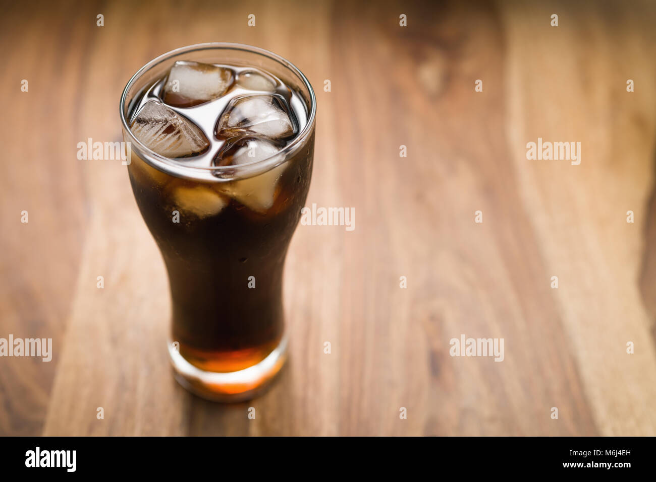 cola with ice in glass on wood table Stock Photo