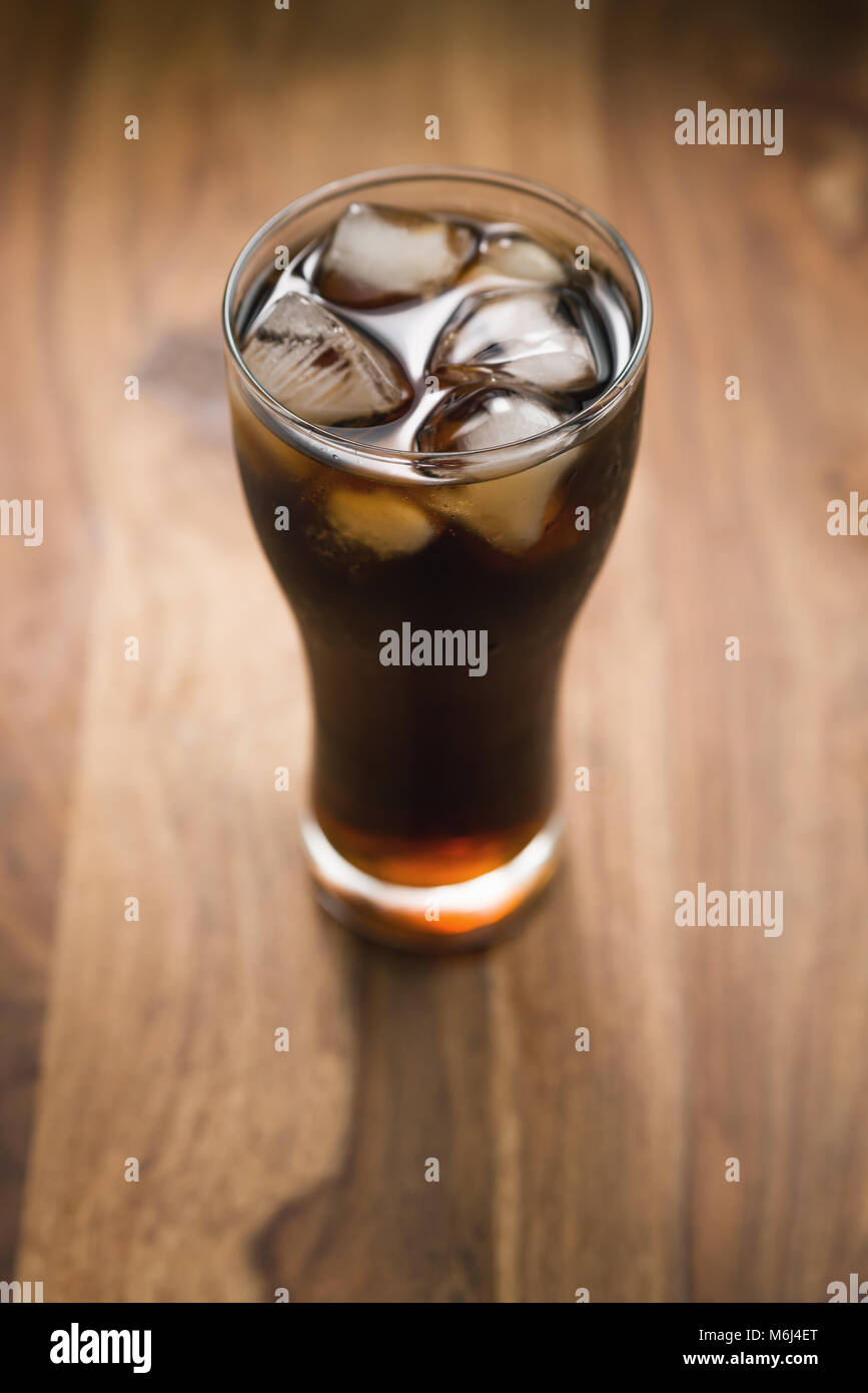 cola with ice in glass on wood table Stock Photo