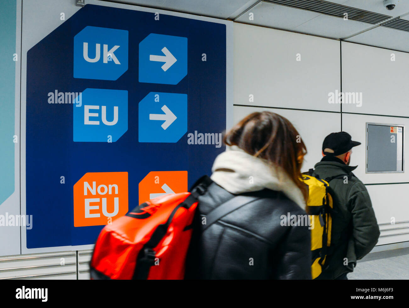 Passengers walks past sign prior to immigration control pass a si Stock Photo