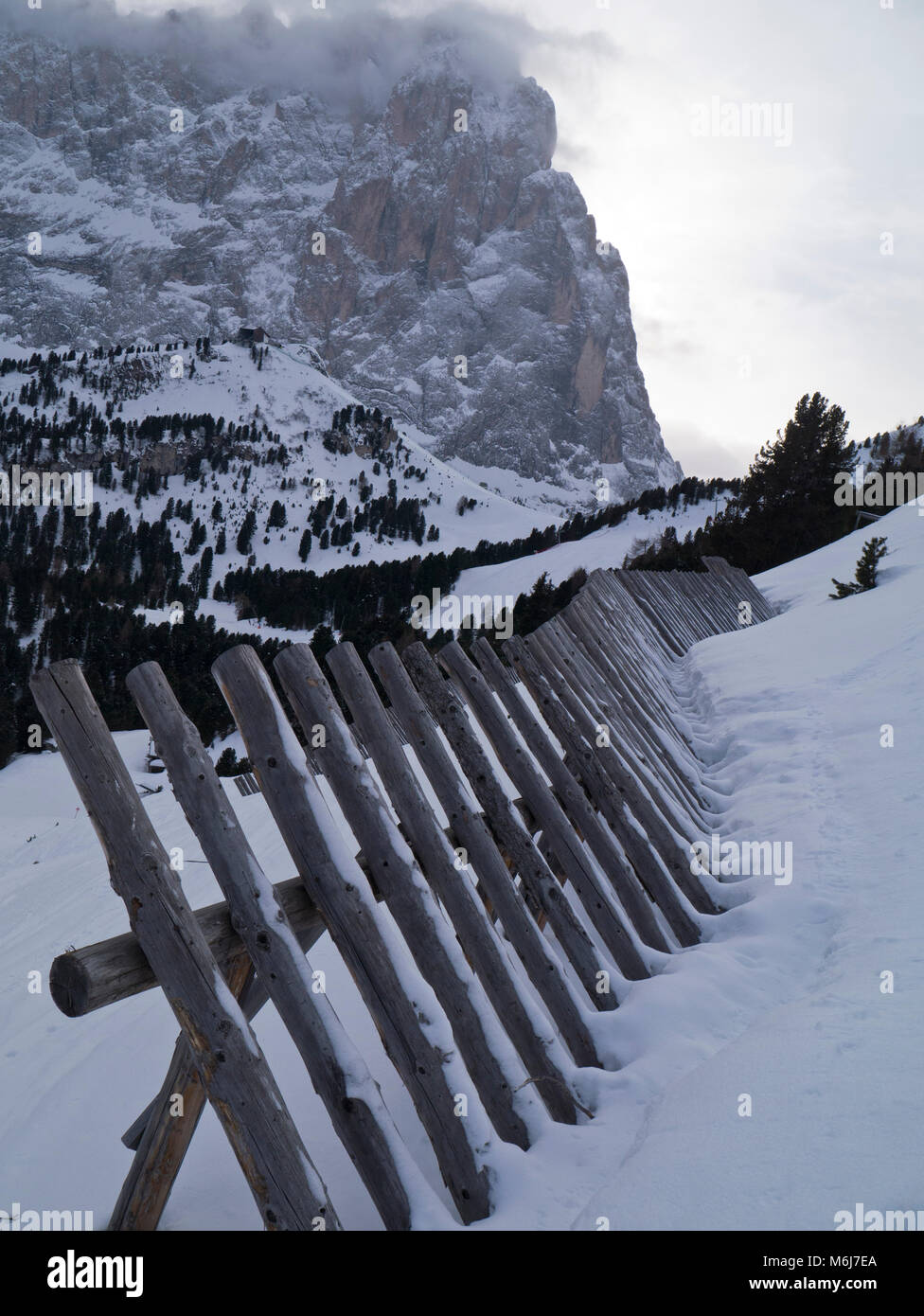 Snow fence in Italian Dolomites Stock Photo