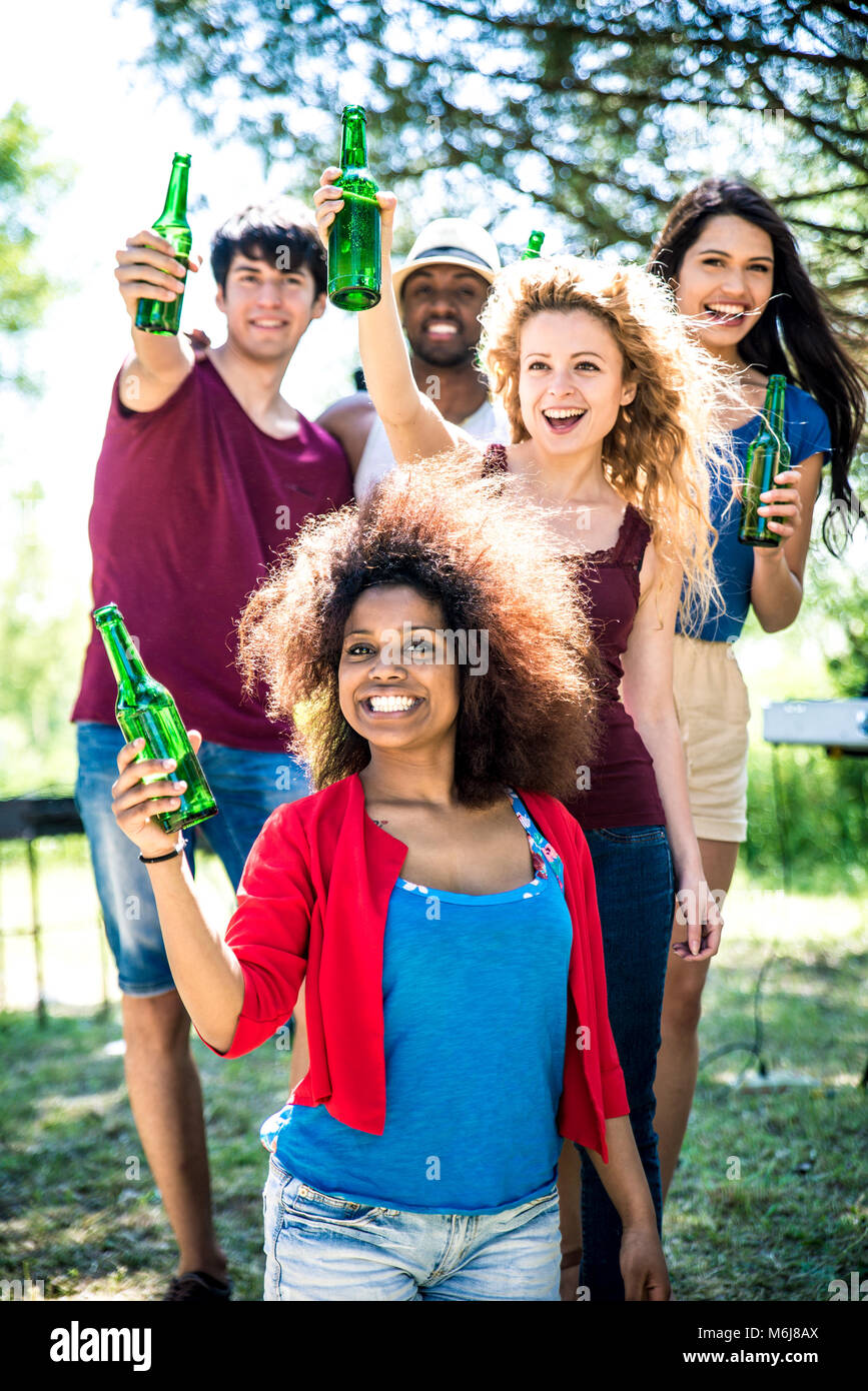 Friends eating at picnic. Making party and dancing in the nature Stock
