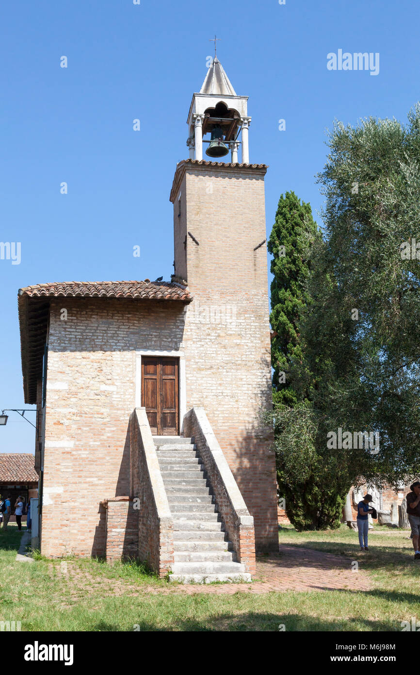 The bell tower on the museum on Torcello Island, Venice, Vento, Italy with tourists sheltering in the shade on a hot summer day Stock Photo