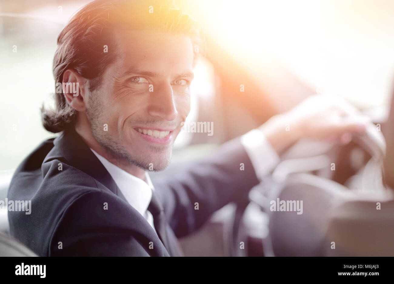 man sitting behind the wheel of a car Stock Photo - Alamy