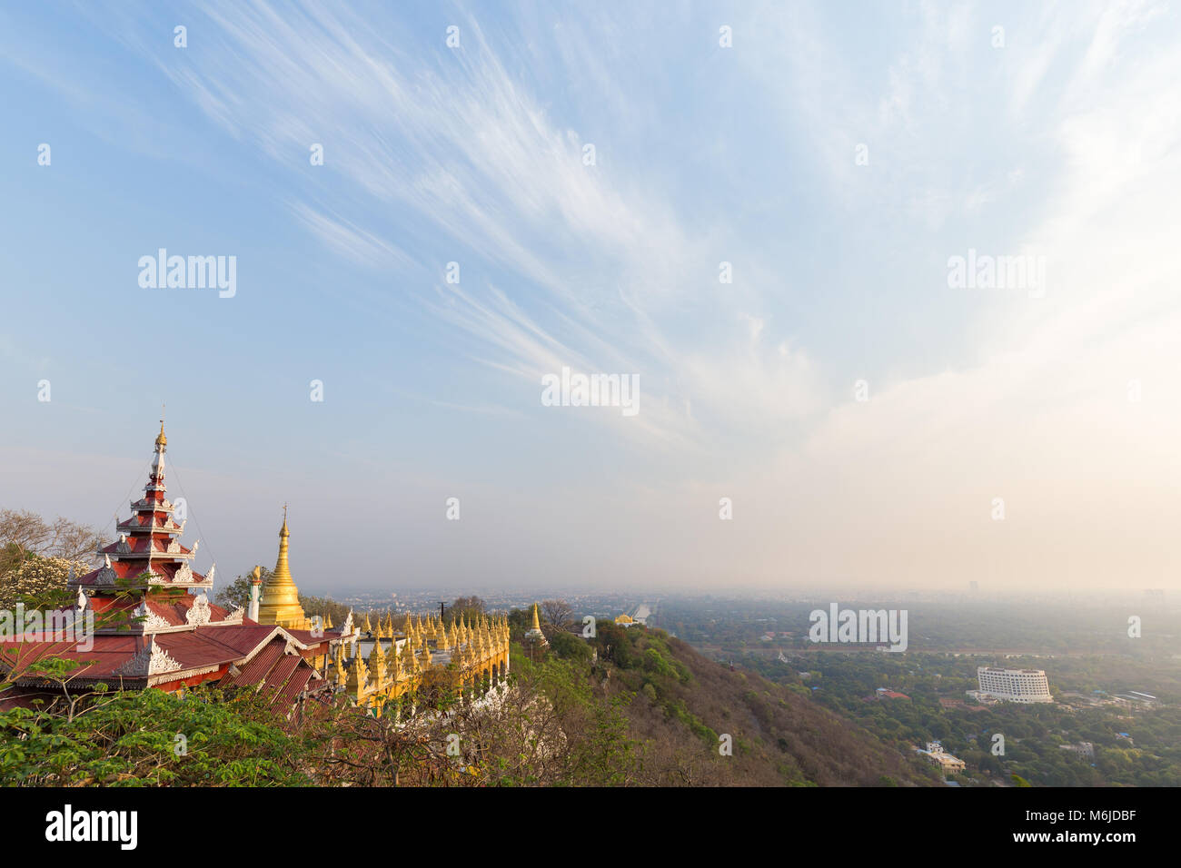 Panoramic view of pavilions and golden pagodas at the Mandalay Hill and the city below in Mandalay, Myanmar (Burma) on a sunny day. Copy space. Stock Photo