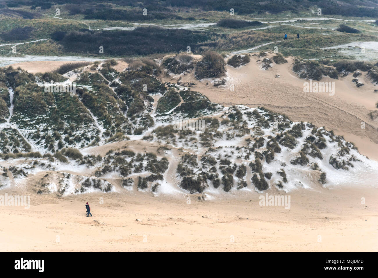 UK weather Snow settling on sand dunes at Crantock Beach in Newquay
