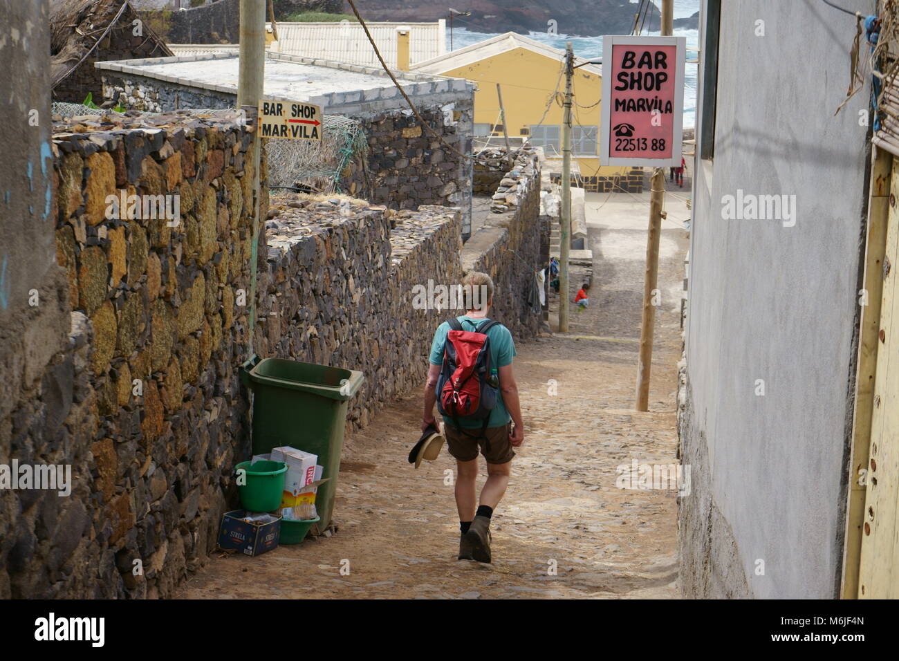 Man walking through Formiguinhas village at the old coastal path from Ponta Do Sol to Cruzinha on the island of Santo Antao, Cape Verde Stock Photo