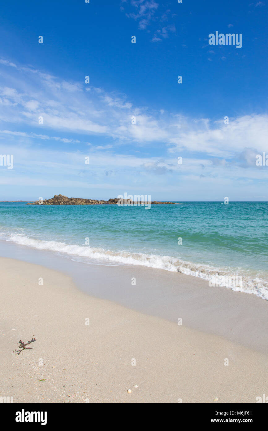 Blue skies over golden sand on the Channel Islands. Stock Photo