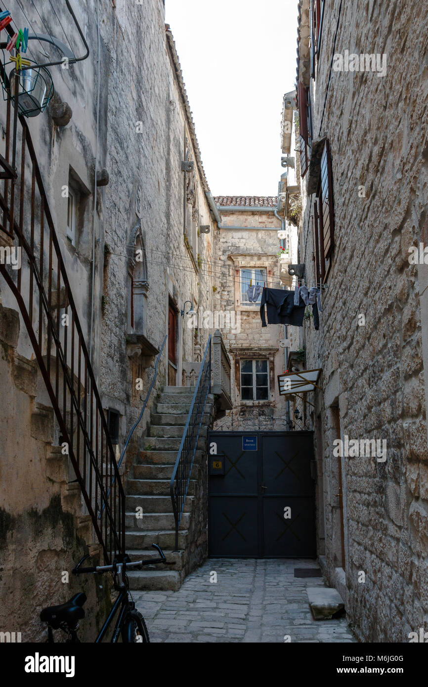 A narrow alleyway in Trogir, Croatia during the day Stock Photo