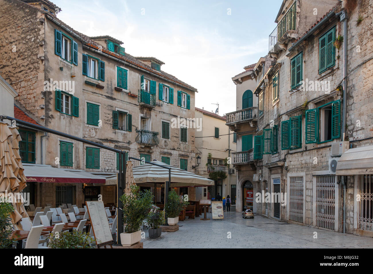 Cafe terraces on a square in the old town of Split during the day Stock Photo