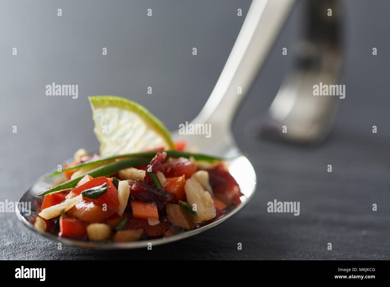 little delicious appetizer on a happy spoon Stock Photo Alamy