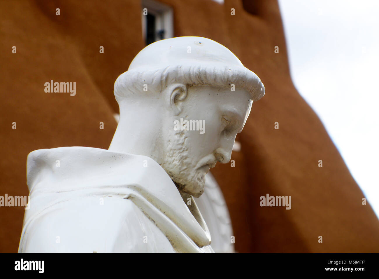 Statue of St. Francis of Asisi in front of  San Francisco de Asis Mission Church in Taos New Mexico Stock Photo