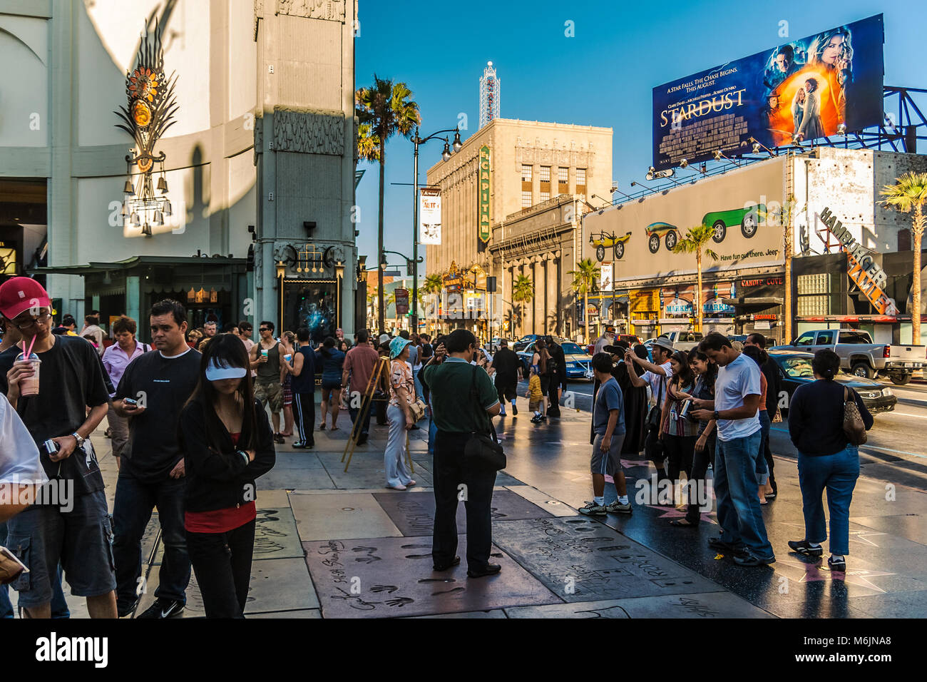 Tourists at the TCL Grauman's Chinese Theatre looking at the prints of famous Hollywood celebrities, Hollywood, Los Angeles, California. Stock Photo