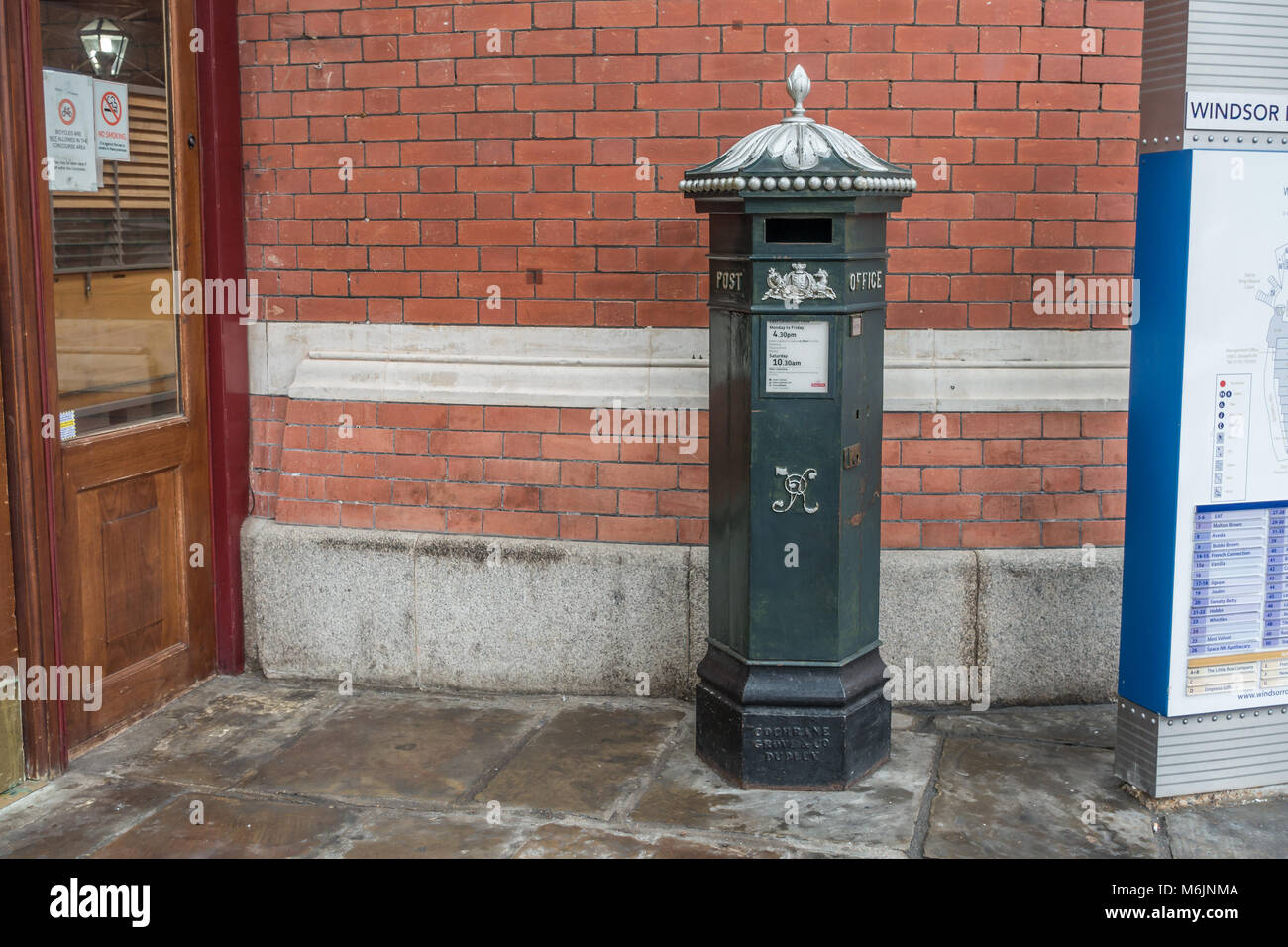 A green Victorian post box in Windsor, UK Stock Photo