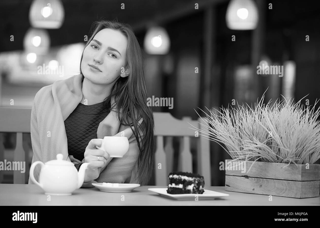 Girl in a cafe sitting and drinking tea Stock Photo Alamy