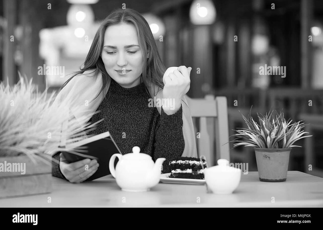 Girl in a cafe sitting and drinking tea Stock Photo Alamy
