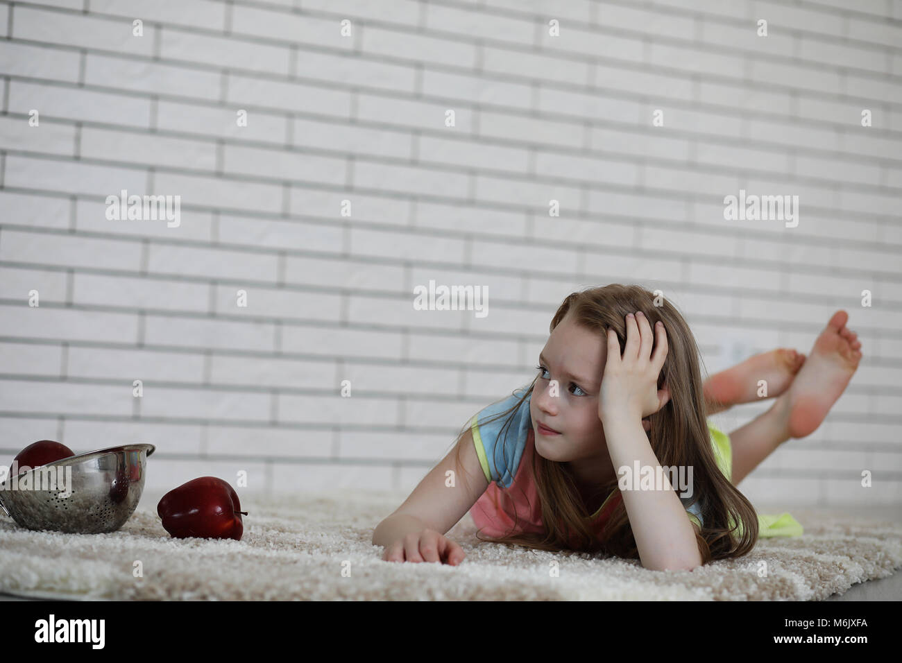little girl lies on the floor Stock Photo - Alamy