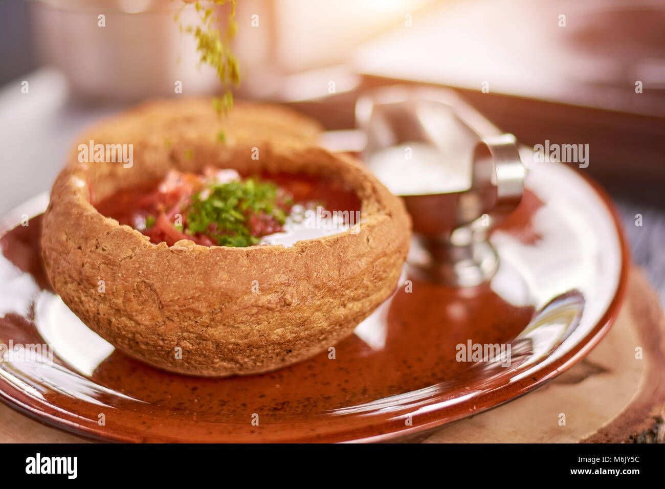 Red beetroot soup in bread pot stock photo alamy