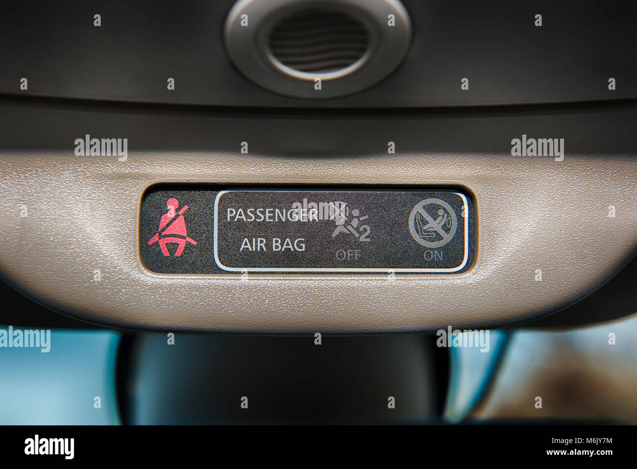 Interior of a car with closeup of of seat belt sign and airbag safety