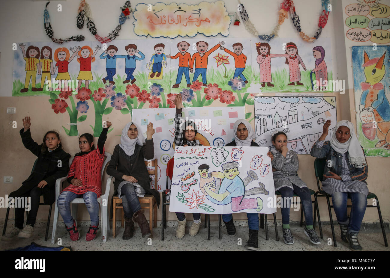 Palestinian children attend a psychological release session battling the long term effects of witnessing violence and growing up in a war zone at a family centre in Nuseirat, central Gaza Strip, 04 March 2018. Israel's closure of the Gaza Strip, particularly restrictions on movement of people and on trading goods, continued to have severe consequences for the civilian population, separating families, restricting access to medical care and educational and economic opportunities, and perpetuating unemployment and poverty. Approximately 70 percent of Gaza·s 1.9 million people rely on humanitarian Stock Photo