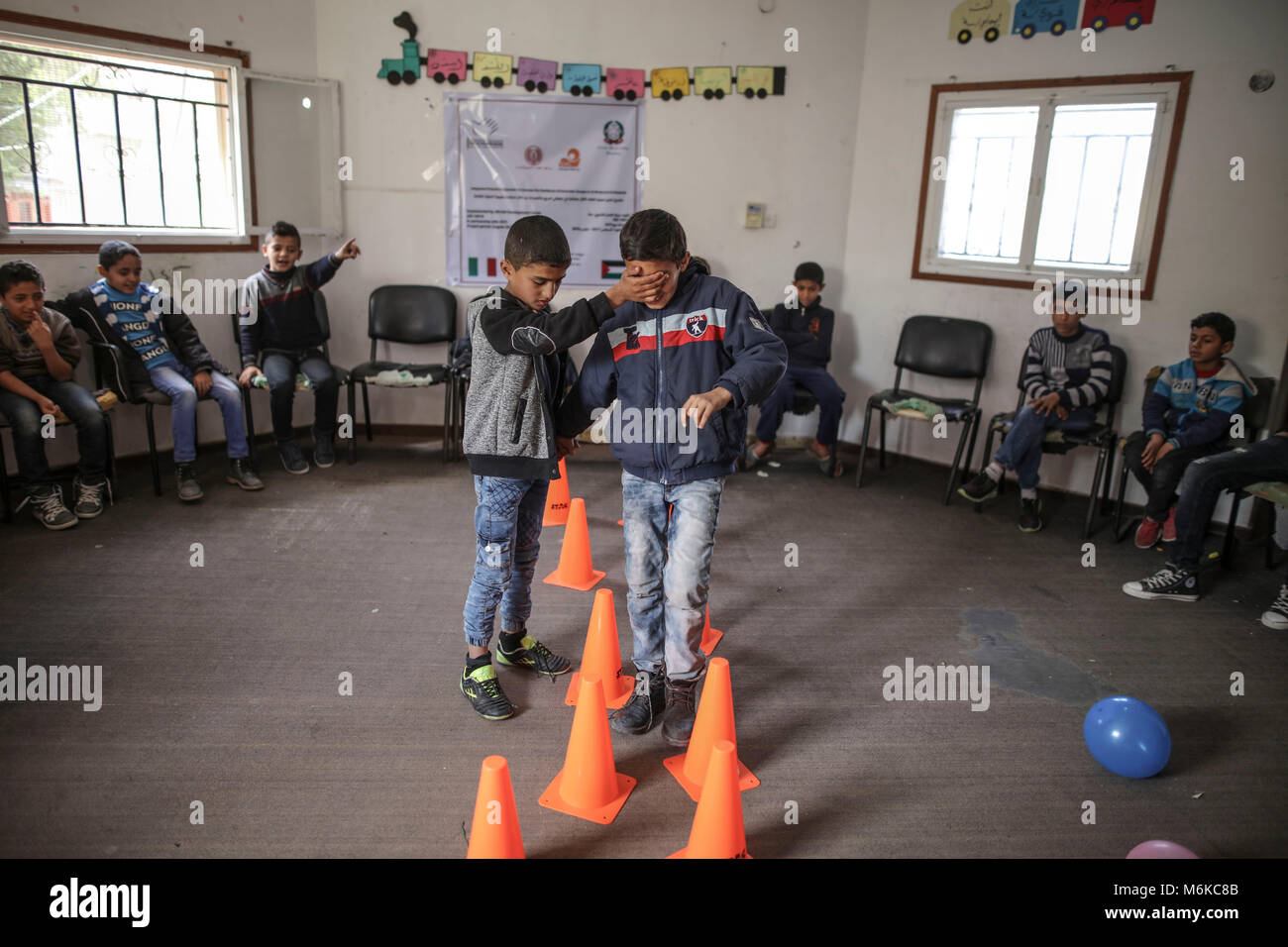 Palestinian children attend a psychological release session battling the long term effects of witnessing violence and growing up in a war zone at a family centre in Nuseirat, central Gaza Strip, 04 March 2018. Israel's closure of the Gaza Strip, particularly restrictions on movement of people and on trading goods, continued to have severe consequences for the civilian population, separating families, restricting access to medical care and educational and economic opportunities, and perpetuating unemployment and poverty. Approximately 70 percent of Gaza·s 1.9 million people rely on humanitarian Stock Photo