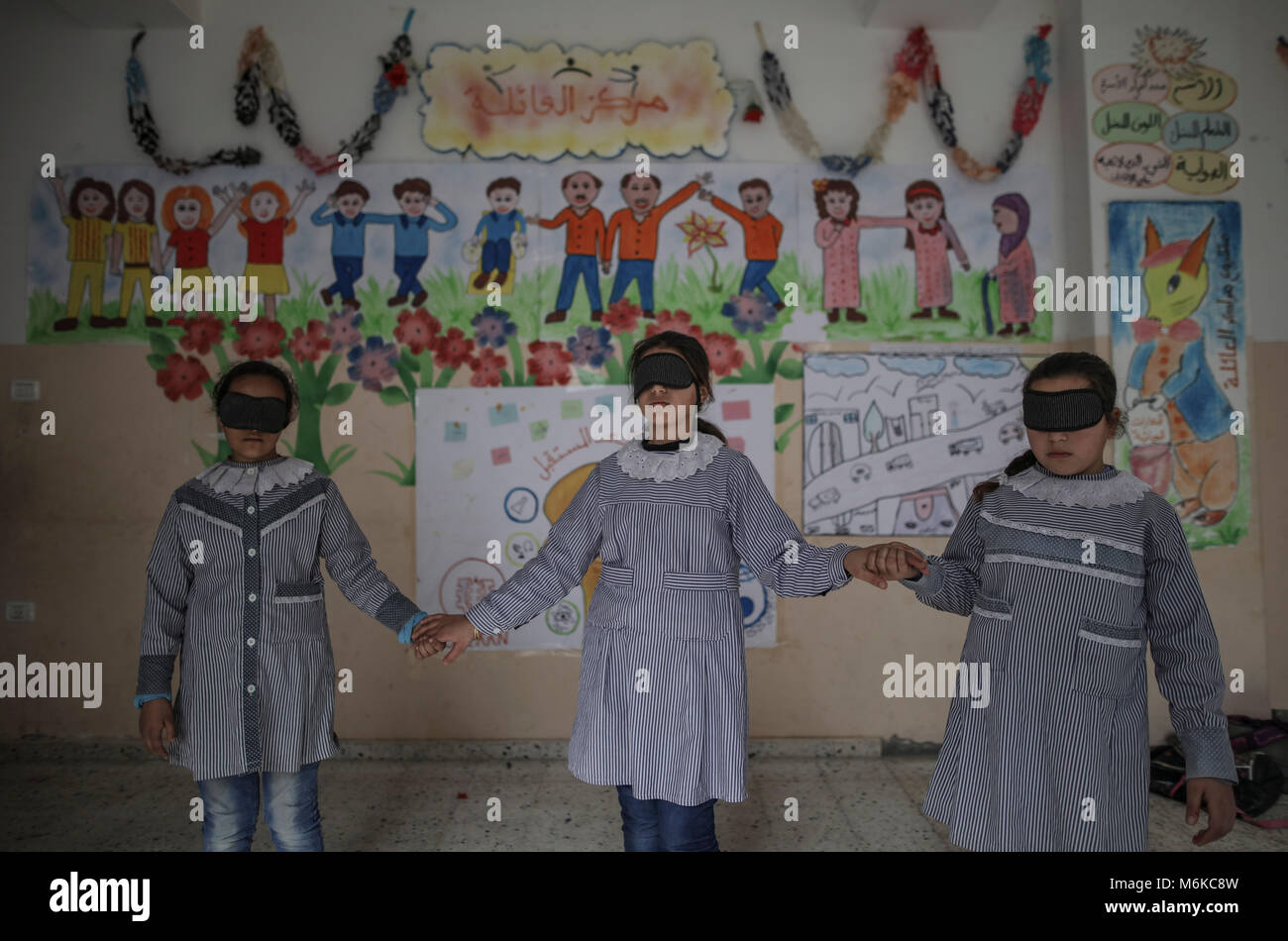 Palestinian children attend a psychological release session battling the long term effects of witnessing violence and growing up in a war zone at a family centre in Nuseirat, central Gaza Strip, 04 March 2018. Israel's closure of the Gaza Strip, particularly restrictions on movement of people and on trading goods, continued to have severe consequences for the civilian population, separating families, restricting access to medical care and educational and economic opportunities, and perpetuating unemployment and poverty. Approximately 70 percent of Gaza·s 1.9 million people rely on humanitarian Stock Photo