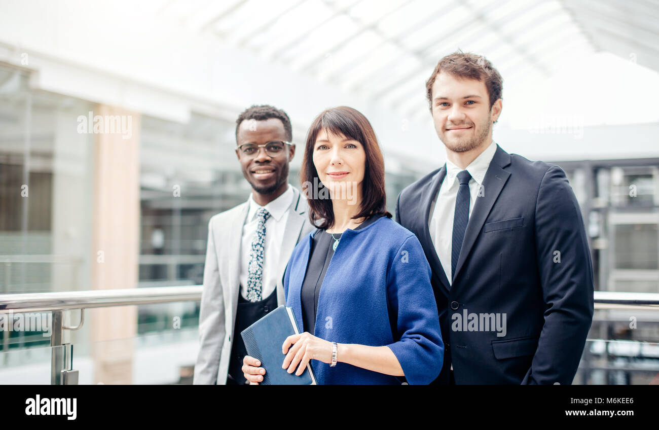 tree successful businesspeople, business team posing in modern office ...