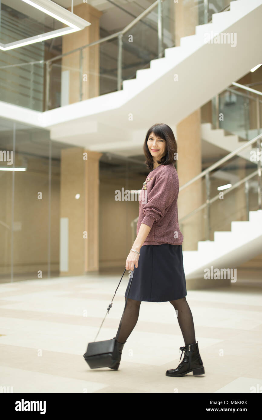 Mature woman confidently walking hi-res stock photography and images ...
