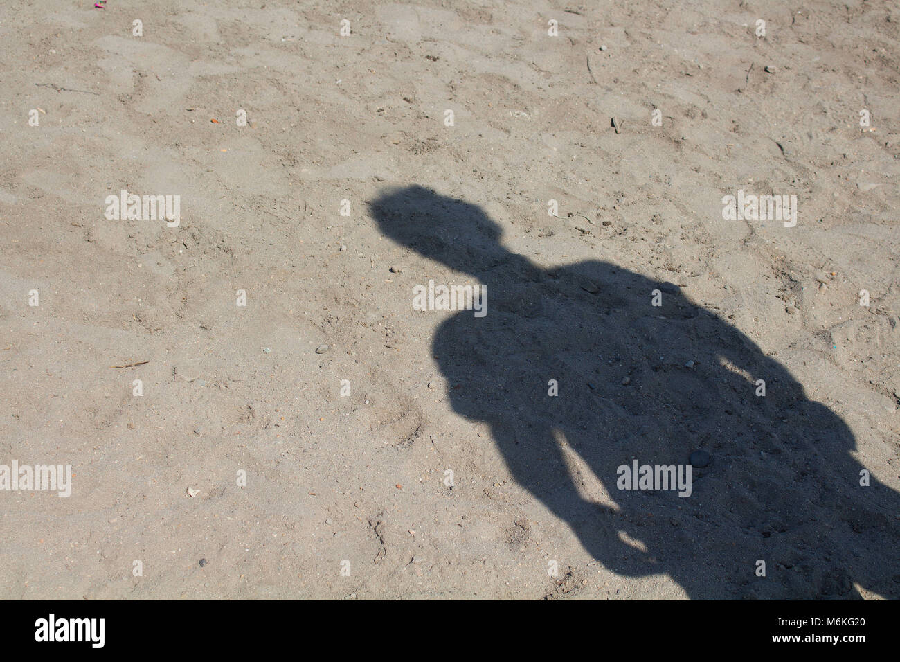 Man shadow on sand background. Stock Photo