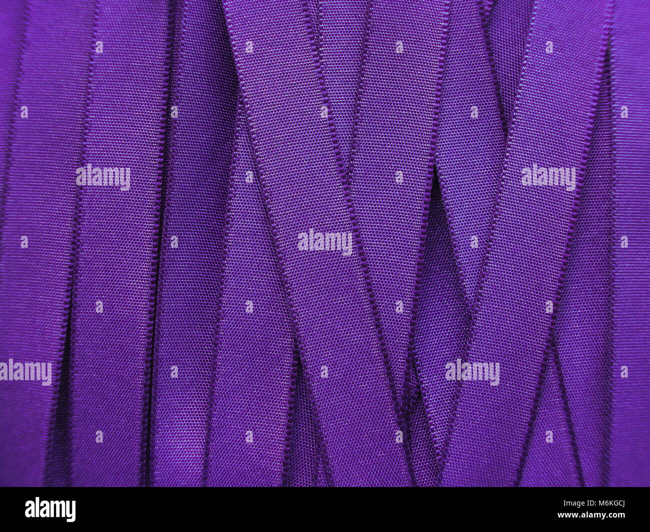 Shiny Purple satin ribbon background Stock Photo - Alamy