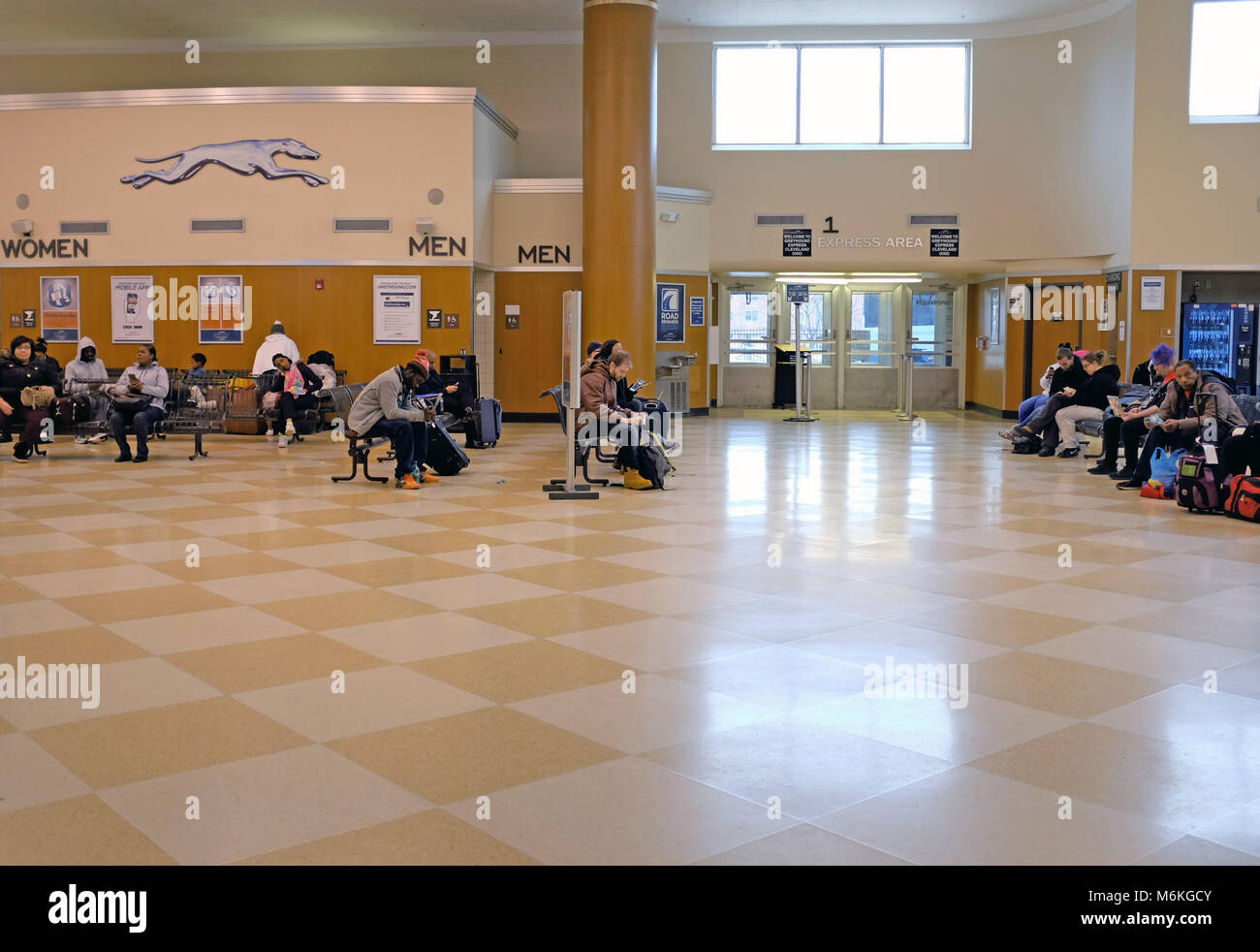 People waiting in the arrivals/departure lobby of the Cleveland, Ohio Greyhound bus station in downtown Cleveland. Stock Photo