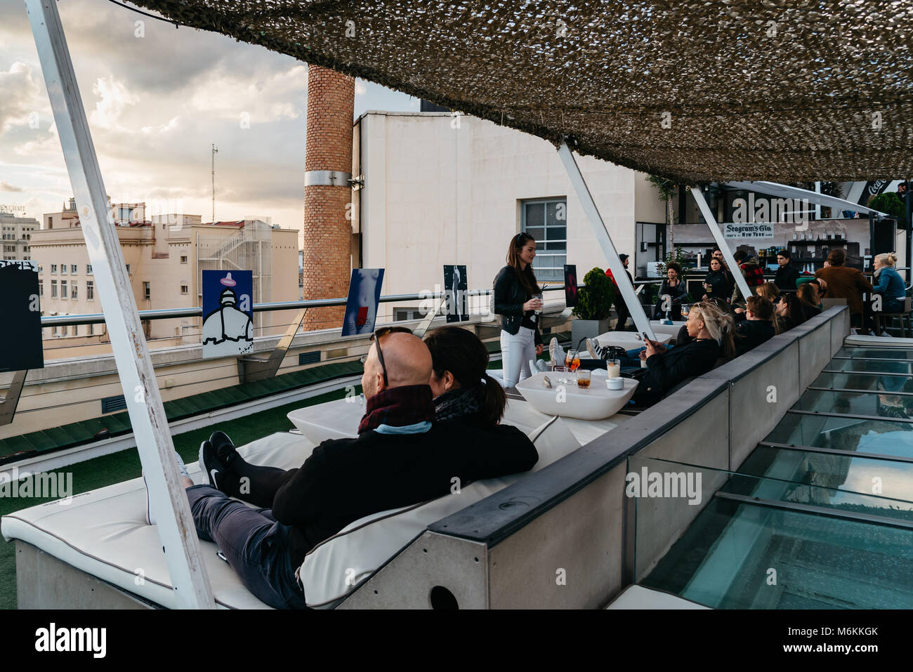 Madrid, Spain - November 3, 2017:  People enjoying at cafe on Circulo de Bellas Artes of Madrid rooftop at sunset. Stock Photo