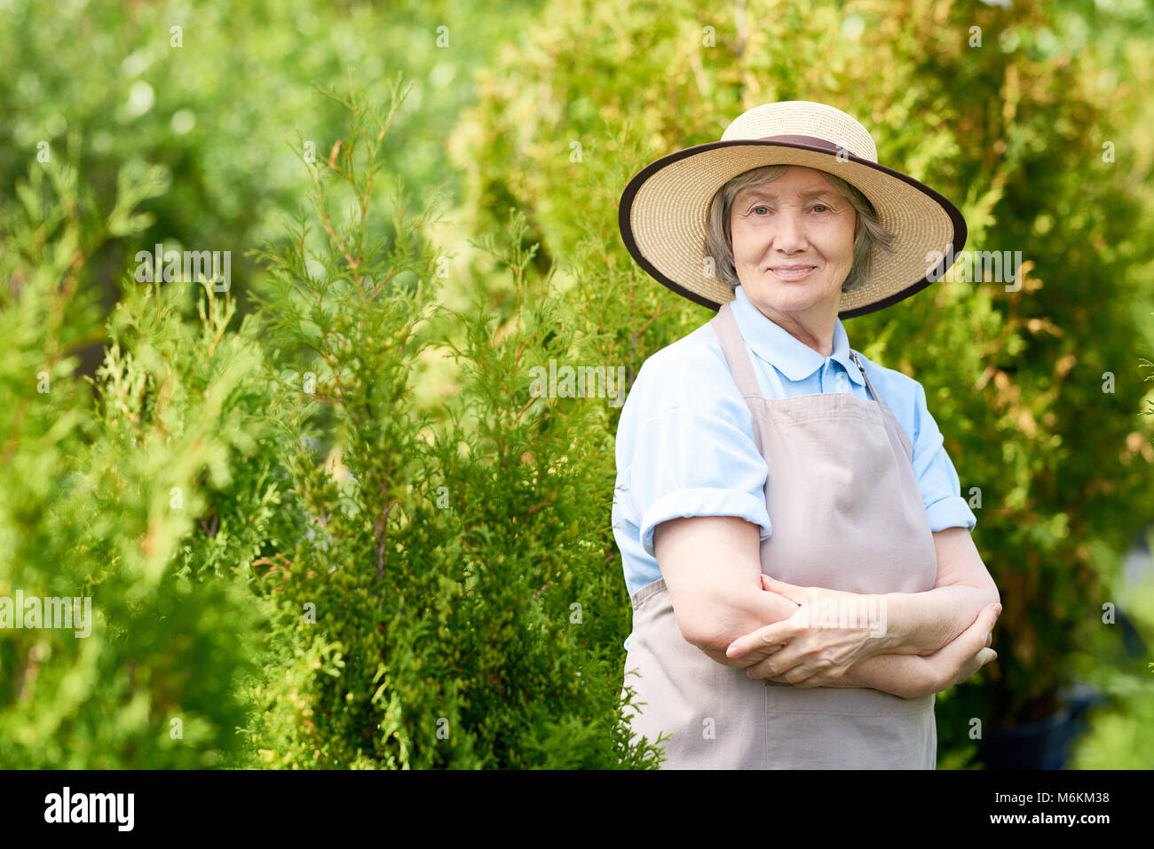 Happy Senior Woman Posing in Garden Stock Photo - Alamy