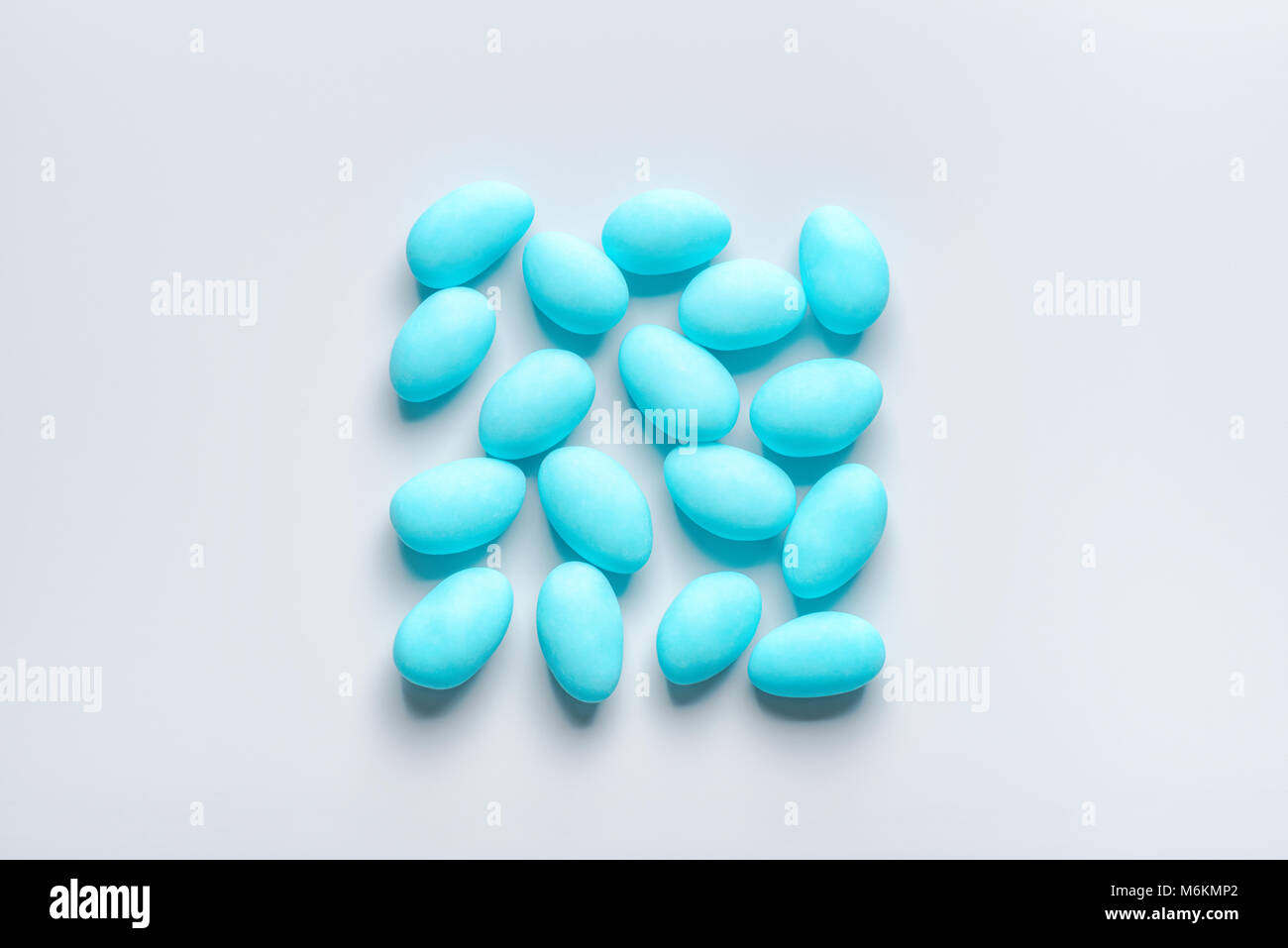 flat lay of blue sugared almond candies square shape on background from ...