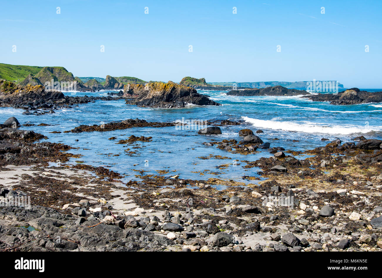 Rocks, cliffs and Atlantic coast at Ballintoy harbor, County Antrim, Norther Ireland, UK. The place featured in the Game of Thrones Stock Photo