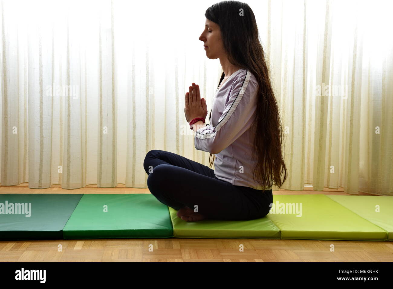 Young woman doing yoga Stock Photo - Alamy