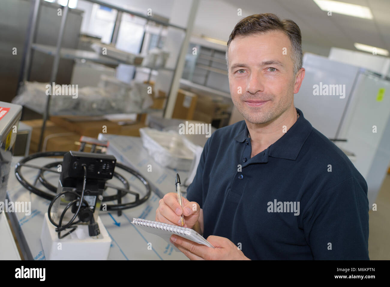 middle age worker doing stocks inventory Stock Photo - Alamy