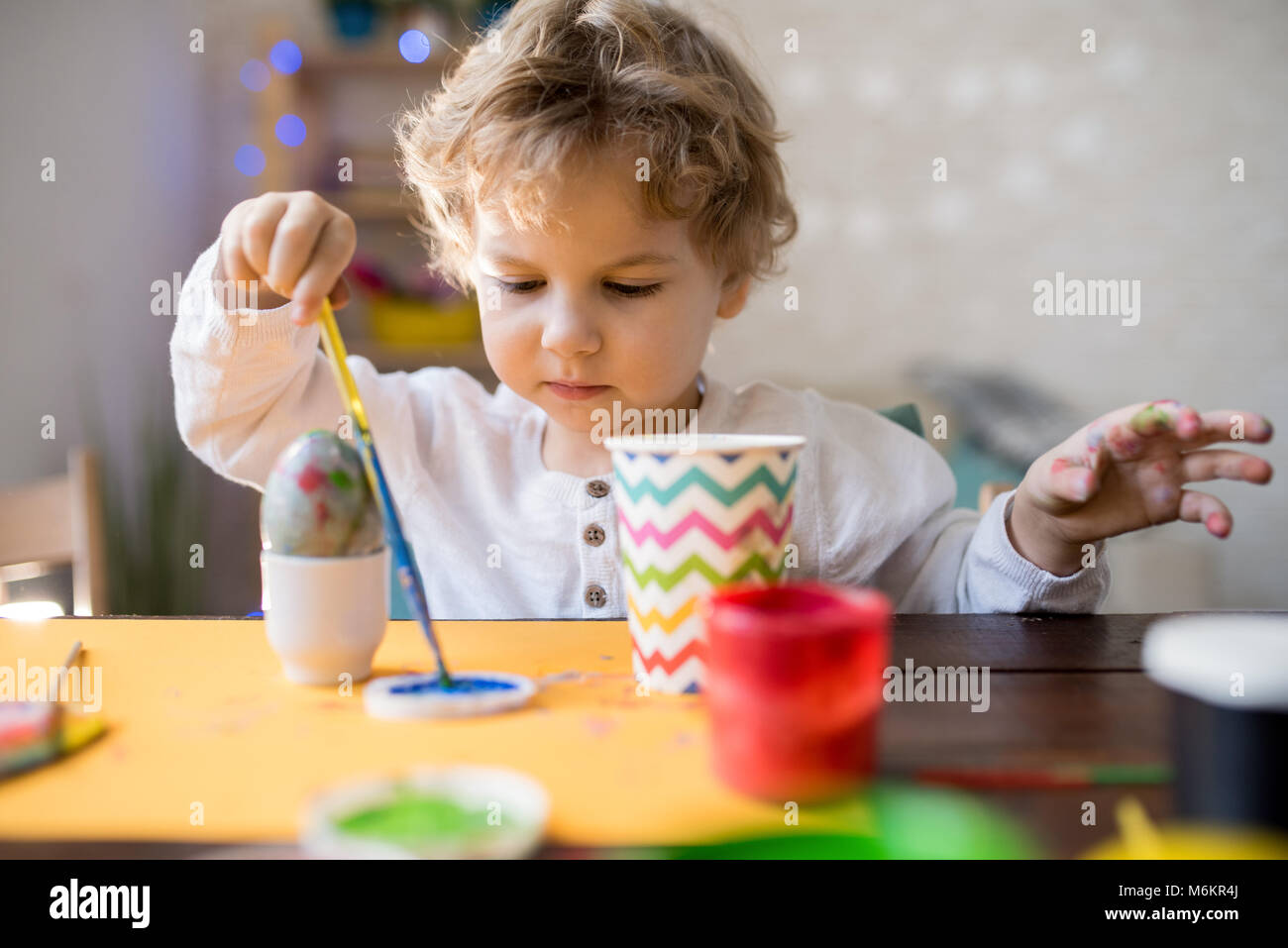 Cute Toddler Painting Easter Eggs Stock Photo