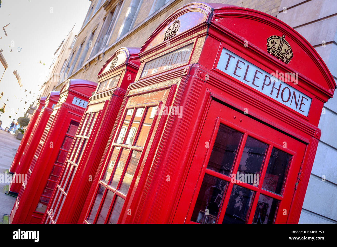 A row of 5 iconic British red telephone boxes in a London Street Stock Photo