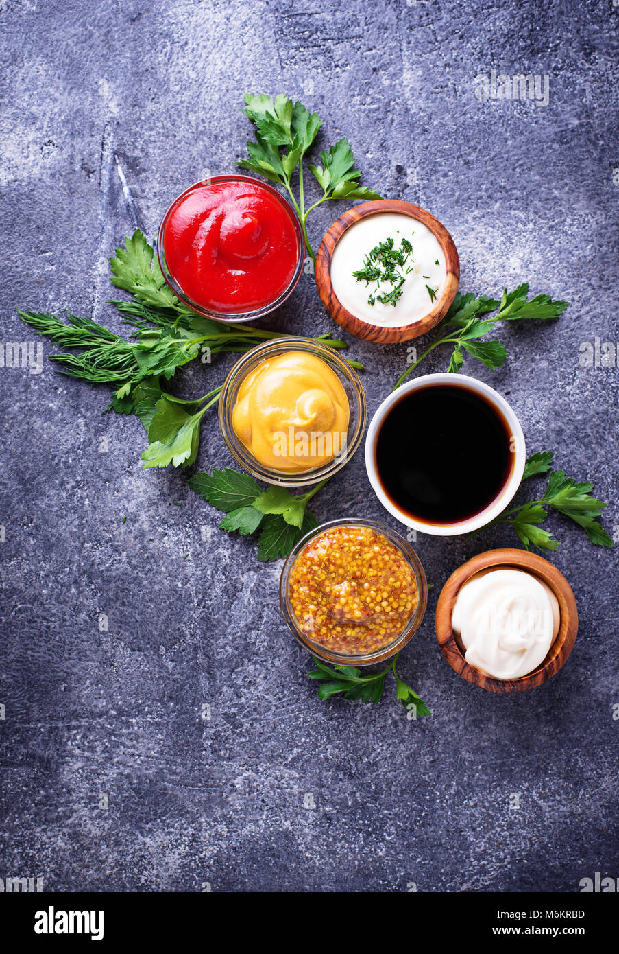 Set of different sauces. Ketchup, mayonnaise, mustard, soy sauce and tartar. Top view Stock