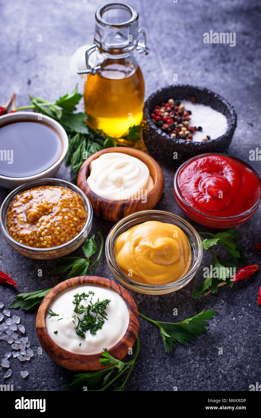 Set of different sauces. Ketchup, mayonnaise, mustard, soy sauce and tartar. Top view Stock