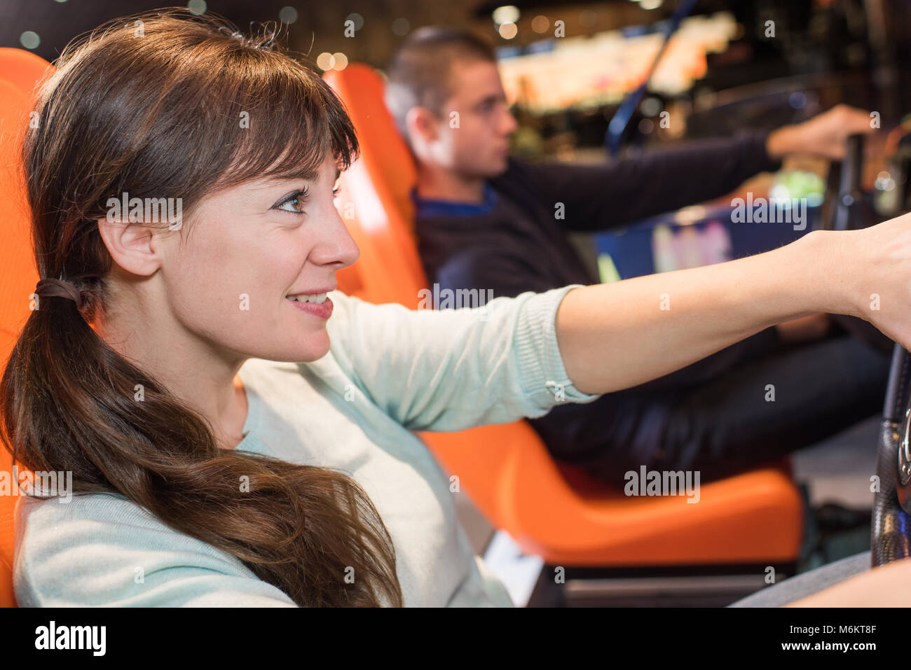 young couple having fun racing in car simulator Stock Photo - Alamy