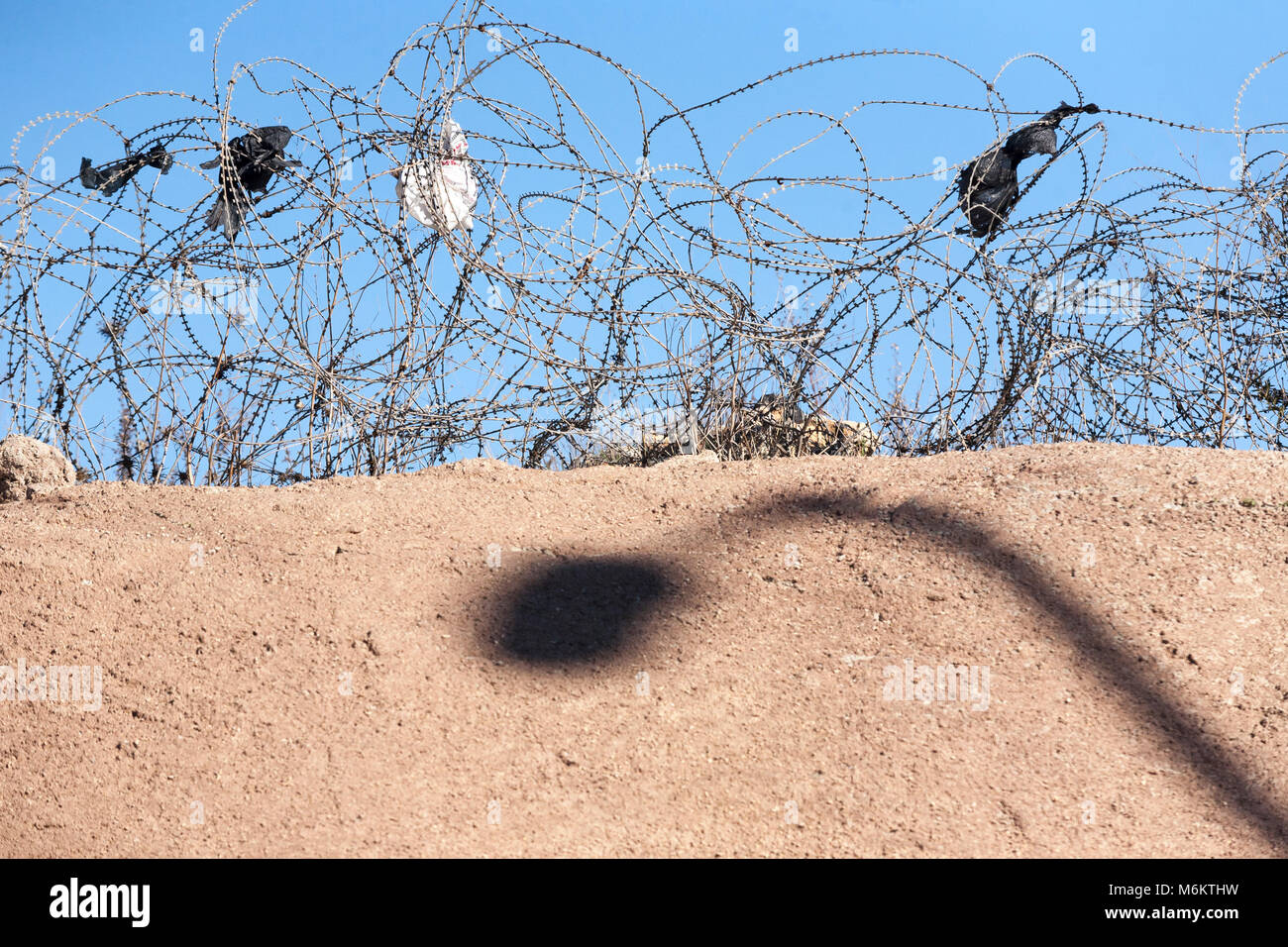 Barbed wire on a desert - like countryside Stock Photo
