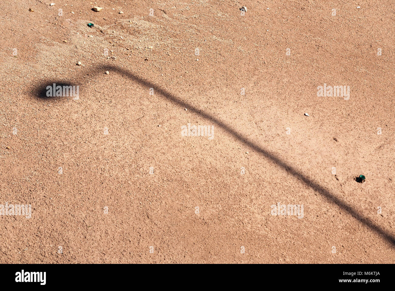 Shadow of a street lamp on a sand Stock Photo