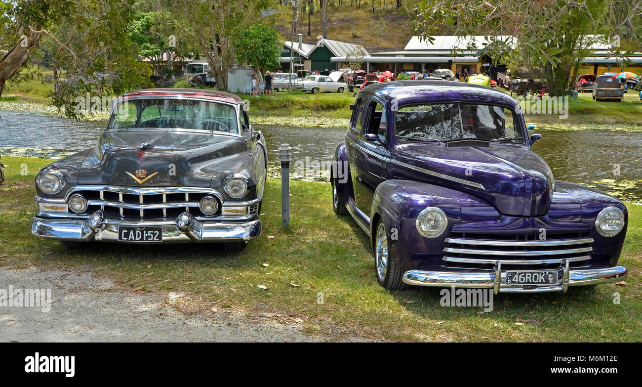1946 ford super deluxe and 1952 cadillac side by side at the rods and rockabilly car show in queensland australia Stock Photo