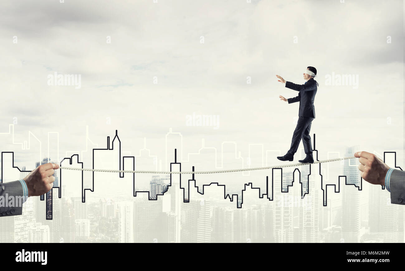 Business concept of risk support and assistance with man balancing on ...